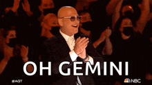 a man in a tuxedo is pointing at the crowd and the words oh gemini are behind him
