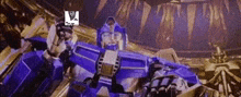 a blue robot is sitting on top of a gold robot in a dark room .