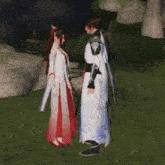 a man and a woman are standing next to each other in a grassy field .