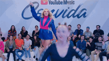 a group of people are sitting in front of a youtube music banner .