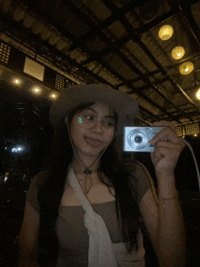 a woman taking a picture of herself with a camera