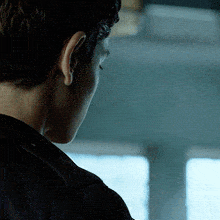 the back of a man 's head is shown in a close up