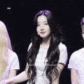 a girl with long black hair is wearing a white shirt with the word taller on it