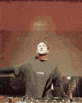 a man wearing a black shirt that says loading is playing music