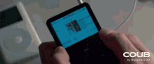 a person is holding a ipod with a blue screen