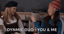 two girls are sitting next to each other in a classroom and dancing .