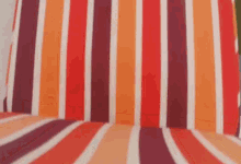 a close up of a colorful striped fabric on a chair .