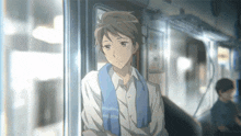 a young man with a blue scarf around his neck