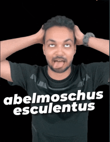 a man making a funny face with the words abelmoschus esculentus behind him