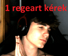 a young man wearing headphones with the words 1 regeart kerek in red behind him