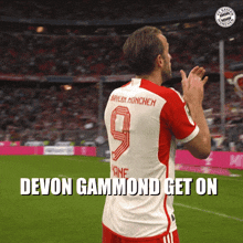a soccer player with the number 9 on his jersey applauds
