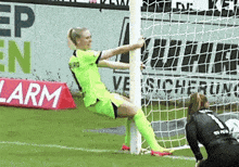a female soccer player in a green jersey with the number 8 on it