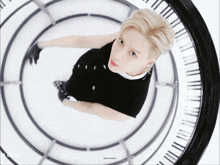 a person looking up at a clock that has the word sunnycity on it