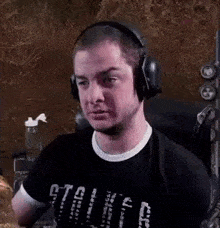 a man wearing headphones is sitting in a chair .