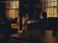 a man and woman sit at a table in a diner with the words terasgifs on the bottom right