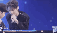a group of people are dancing on a stage with chinese writing