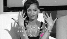 a woman with black nails is sitting on a couch with her hands up in the air .