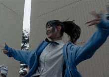 a girl wearing a blue jacket has the number 2 on her shirt