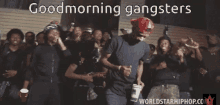 a group of men are dancing in front of a building with the words good morning gangsters above them