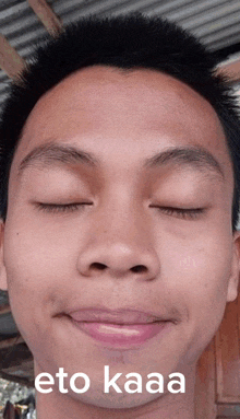 a close up of a man 's face with the words " eto kaaa " on the bottom right