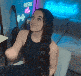a woman sitting on a couch in front of a hustle sign