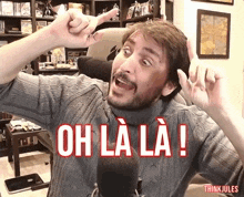 a man in front of a microphone with the words oh la la written in red