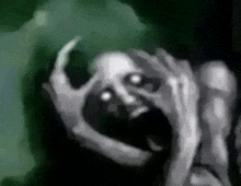 a black and white drawing of a scary face with glowing eyes