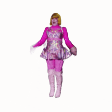 a drag queen in a pink dress and pink boots is dancing on a stage .