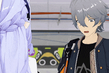 a boy with gray hair is wearing a black shirt that says a