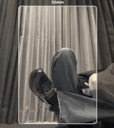 a black and white photo of a person 's feet with a 35mm border