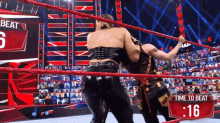 two women in a wrestling ring with the time to beat being 16 seconds
