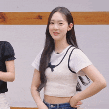 a girl in a white crop top is smiling