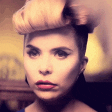 a close up of a woman 's face with a serious look on her face