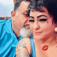 a woman with a tattoo of a red kiss on her chest