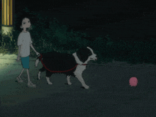 a boy is walking a dog in the dark