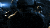 a group of soldiers are standing in a dark room and one of them is wearing a helmet that has the letter a on it
