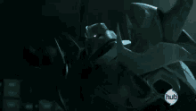 a close up of a robot with red eyes and horns in a dark room .