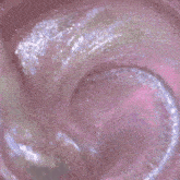 a person is stirring a pink liquid with a spoon in a pink bowl .