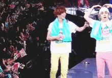 a couple of people standing on a stage with one wearing a shirt that says ' tokyo ' on it