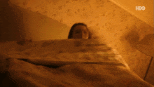a blurry picture of a woman wrapped in a blanket with hbo on the bottom left