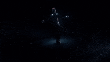 a silhouette of a person with their arms outstretched