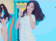 a girl in a white dress is making a face