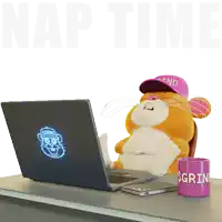 a stuffed animal is sitting in front of a laptop and a mug that says grind on it