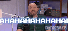 a bald man is laughing in front of a microphone with the words ahaha ahaha ahaha dark web behind him