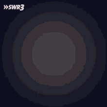 a blurry picture of a man in a santa suit with the letters swr3 on the bottom right