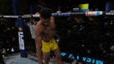 a fighter in a cage with a sign that says ufc apex on it