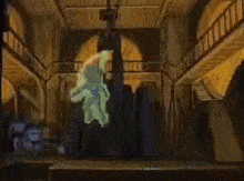 a person is hanging from a ceiling in a room with stairs