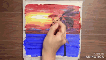 a person is painting a sunset with the words made in animotica below it