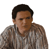 a young man wearing a striped shirt looks serious