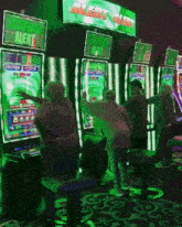a group of people are playing a slot machine under a green sign that says alert alert